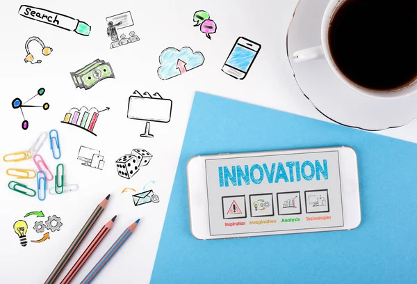 Concetto di innovazione. Telefono cellulare e tazza di caffè su una scrivania bianca — Foto Stock