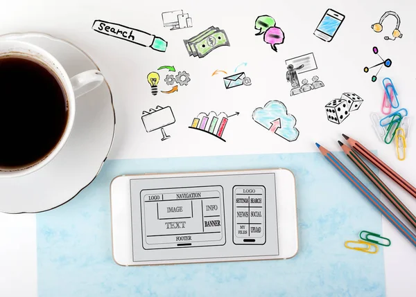 Desarrollo de sitios web y aplicaciones móviles Concepto. Teléfono móvil y taza de café en un escritorio de oficina blanco — Foto de Stock