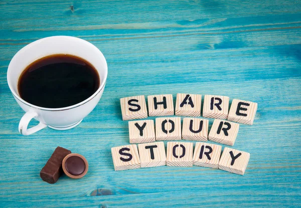 share your story. Coffee mug and wooden letters on wooden background