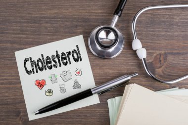 Cholesterol, Workplace of a doctor. Stethoscope on wooden desk background clipart