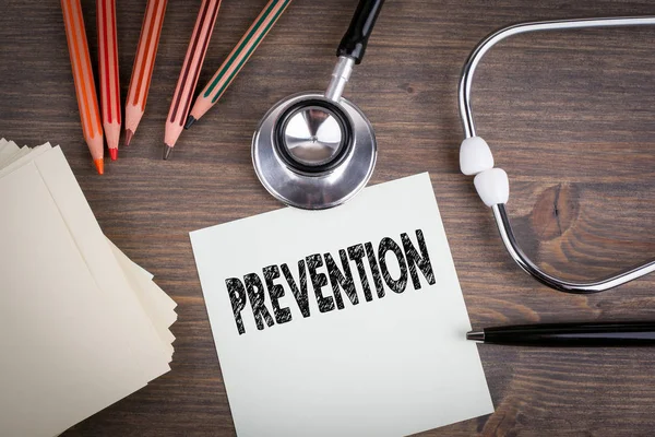 Prevention. Workplace of a doctor. Stethoscope on wooden desk background — Stock Photo, Image