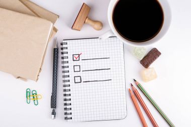 Boş kontrol listesi ile beyaz Ofis Masası üzerinde kitap