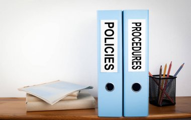 Policies and Procedures binders in the office. Stationery on a w clipart