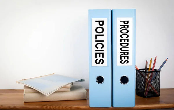 Policies and Procedures binders in the office. Stationery on a w — Stock Photo, Image