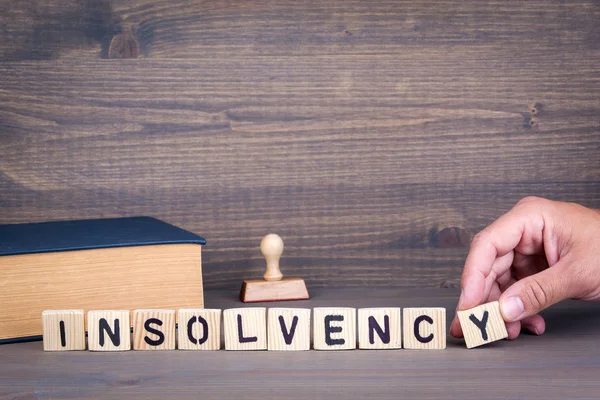 Insolvency. Wooden letters on dark background — Stock Photo, Image