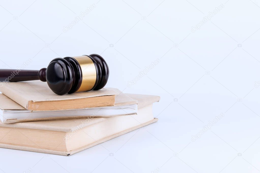 Wooden gavel and books in background. Law and justice concept