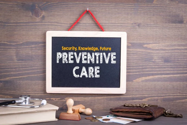 Preventive Care concept. Chalkboard on a wooden background