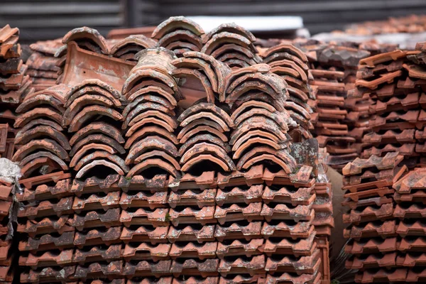 Starej dachówki płytki ułożone na paletach drewnianych. Tło dla renowacji konstrukcji i logistyki — Zdjęcie stockowe