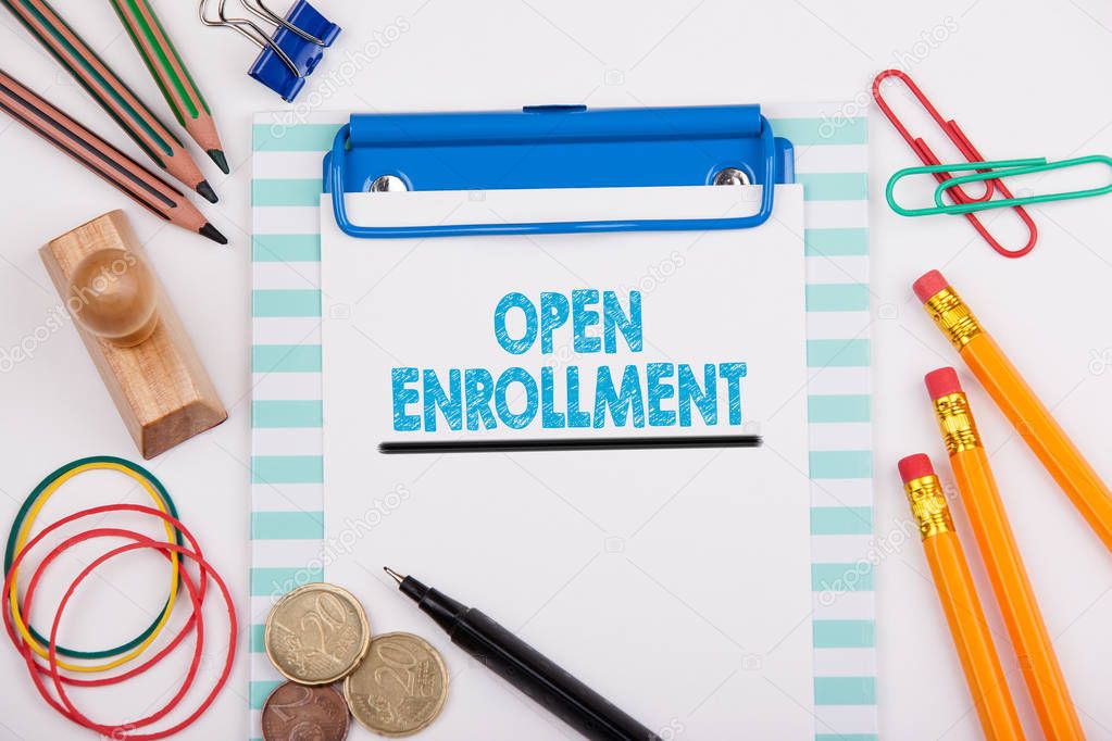 Open Enrollment. White office desk with stationery