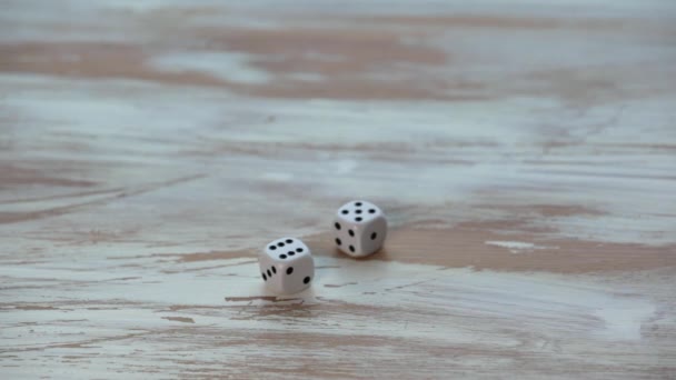 White small dices on wooden texture table — Stock Video