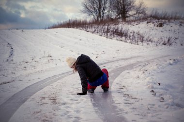 Slip on the slippery ice and snow on the road track at the country in freezing winter day clipart