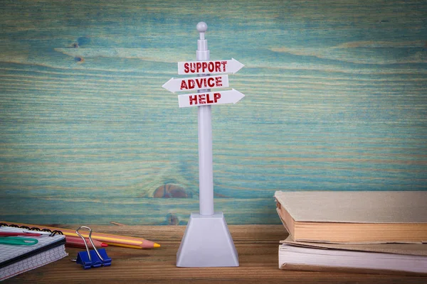 support advice help, customer support. Signpost on wooden table