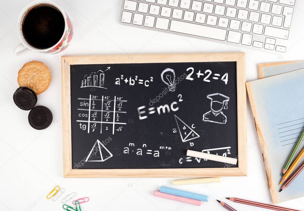 math formulas, education and knowledge concept. Chalkboard on white office desk