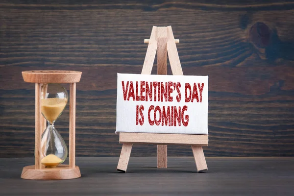 Valentijnsdag komt. Sandglass, zandloper of ei timer op houten tafel — Stockfoto