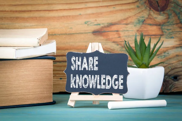 Share knowledge. small wooden board with chalk on the table