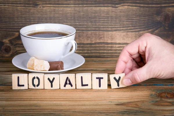 Loyalität. Holzbuchstaben auf dem Schreibtisch, Informations- und Kommunikationshintergrund — Stockfoto