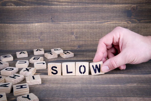 Slow. Wooden letters on the office desk — Stock Photo, Image