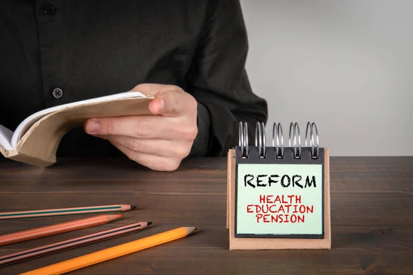 Reform. Health, Education and Pension concept. Man reading a book