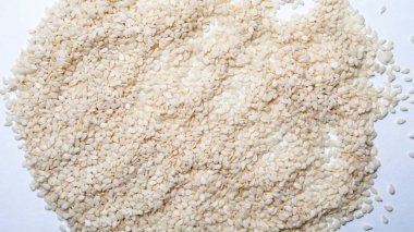 Beyaz arka planda organik doğal susam tohumları