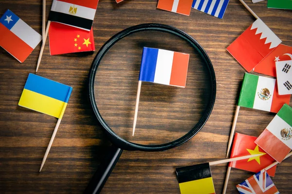 French flag. Flags of many countries, magnifying glass on table