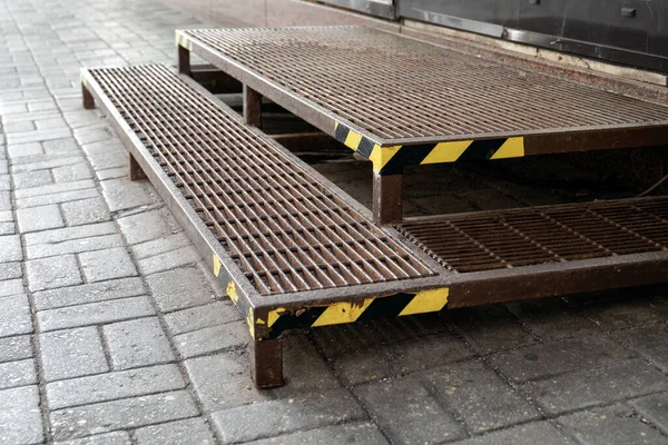 Warning tape on metal stairs outdoors by sidewalk — Stock Photo, Image