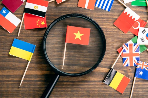Flag of Vietnam. Flags of many countries, magnifying glass on table — стокове фото