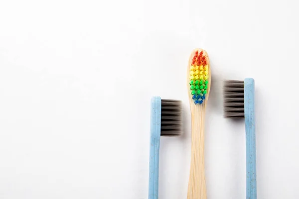 Three toothbrushes on a white background. Relationships, choices, sexual health and equality concept — Stock Photo, Image