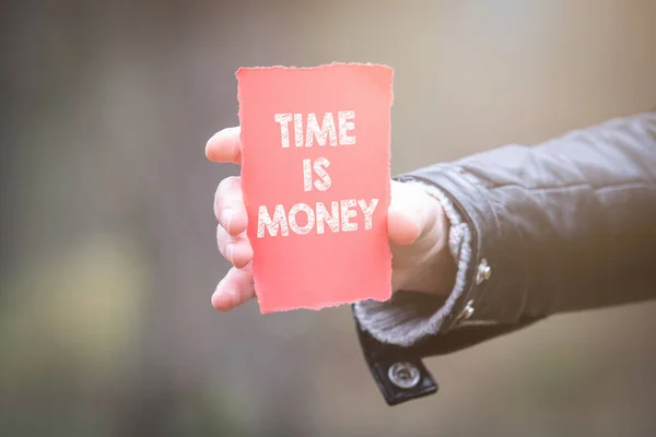 TIME IS MONEY concept. Text on the sheet in hand — Stock Photo, Image