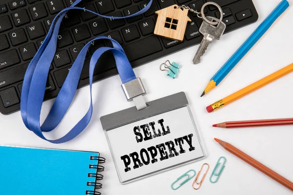 SELL PROPERTY concept. Staff Identity, colored pencils and black computer keyboard — Stock Photo, Image