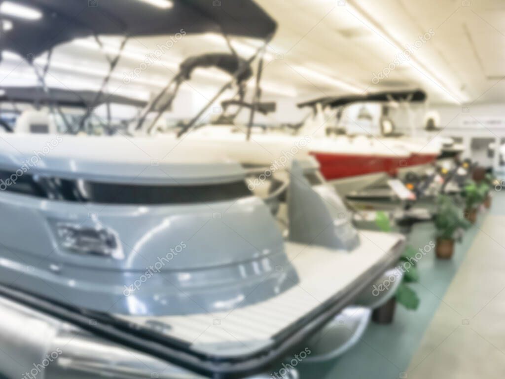 Blurry background customer showing boat at large indoor showroom in America