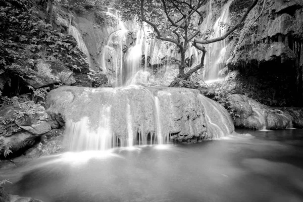 Toned photo huge round rock and tranquil pond in rain forest at Thac Voi waterfall, Thanh Hoa