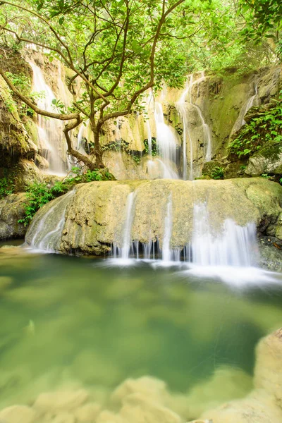 Huge round rock and tranquil pond in rain forest at Thac Voi waterfall, Thanh Hoa