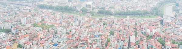 Panoramic top view high-density housing along To Lich River in Hanoi, Vietnam foggy day