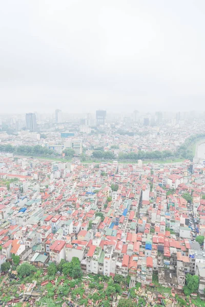 Aerial view cemetery and high-density housing along To Lich River in Hanoi, Vietnam foggy day