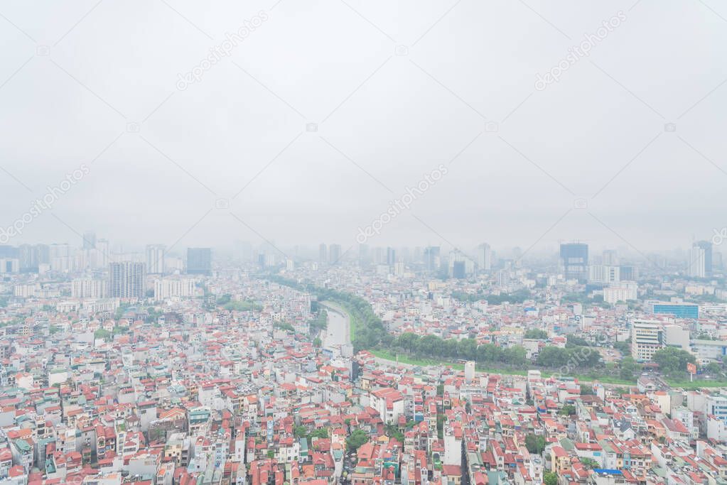 Top view high-density housing along To Lich River in Hanoi, Vietnam foggy day