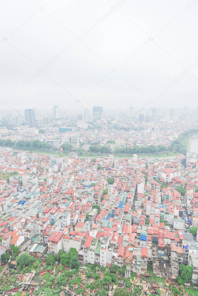 Aerial view cemetery and high-density housing along To Lich River in Hanoi, Vietnam foggy day