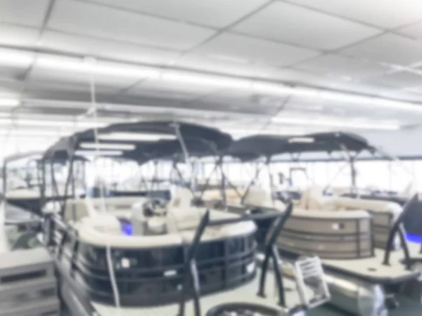 Motion blurred inside a large boat dealer selling variety of new and used boats near Dallas, Texas, USA. recreational boating buying, trade-in and servicing concept