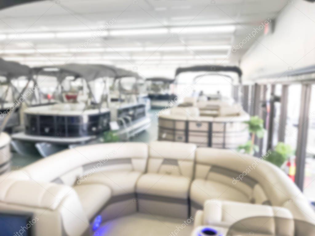Motion blurred inside a large boat dealer selling variety of new and used boats near Dallas, Texas, USA. recreational boating buying, trade-in and servicing concept