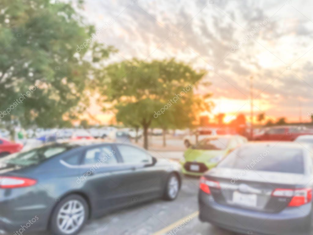 Blurred motion dramatic sunset cloud at uncovered parking lots of grocery store near Dallas, Texas, America.