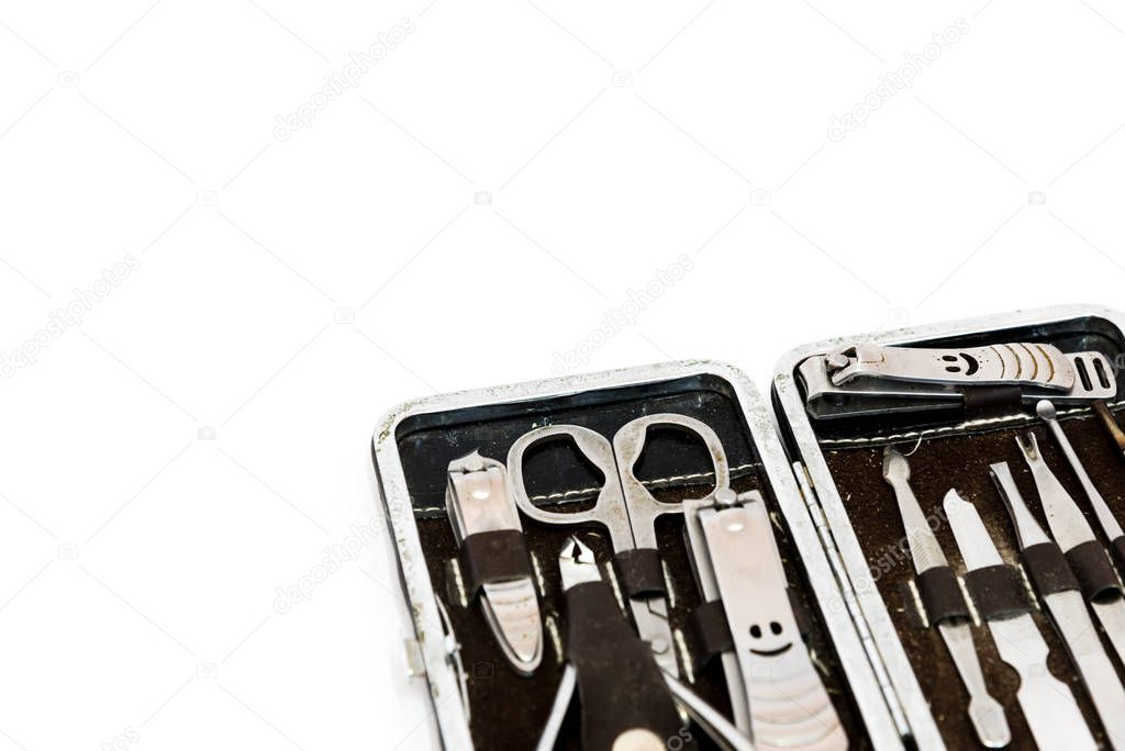 Close-up pedicure kit, nail clippers, professional grooming kit, nail tools with travel case isolated on white background.