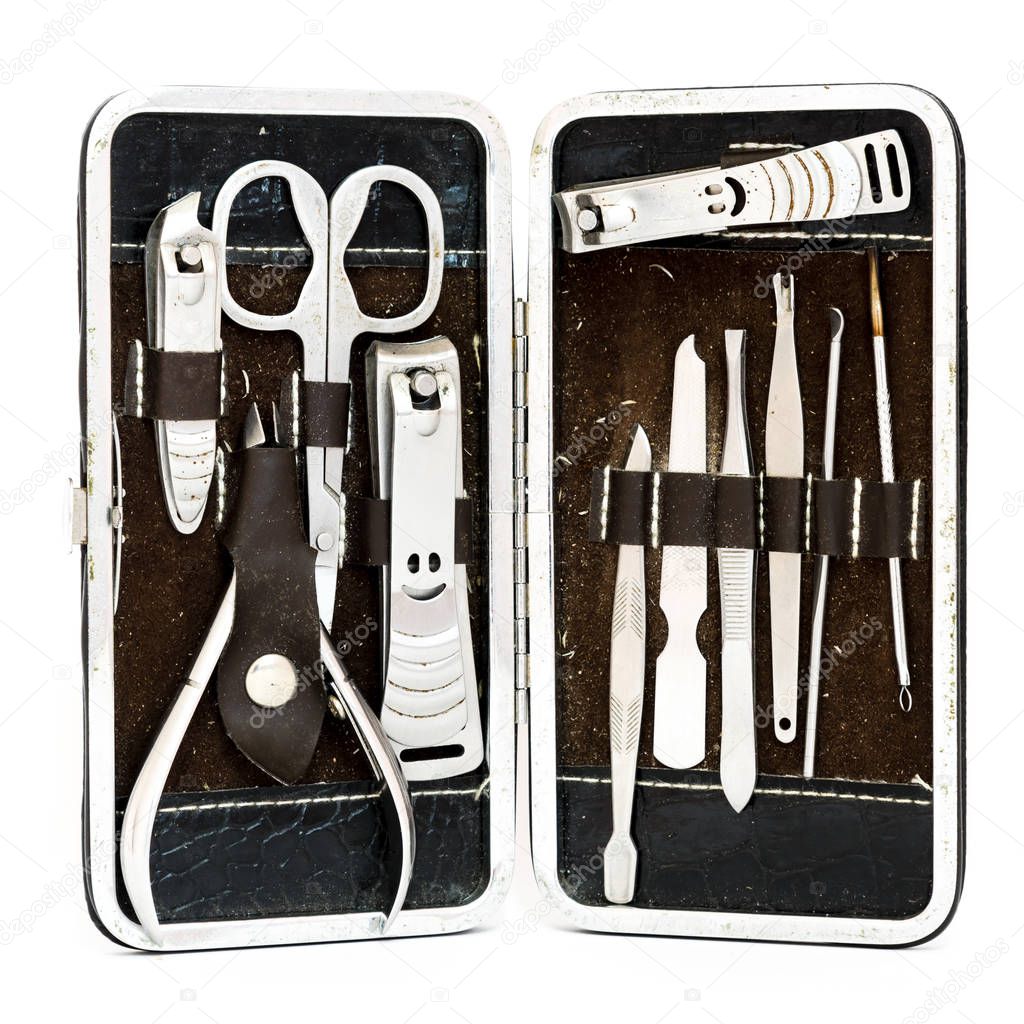 Top view close-up pedicure kit, nail clippers, professional grooming kit, nail tools with travel case isolated on white background.