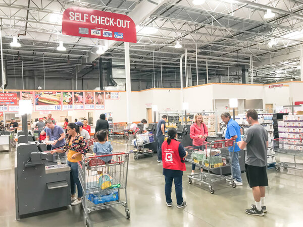 DALLAS, TX, US-OCT 19, 2019: Busy customers at self-checkout kiosks area of Costco in Churchill Way, Dallas. This option available at 125 wholesale stores to help reduce long lines