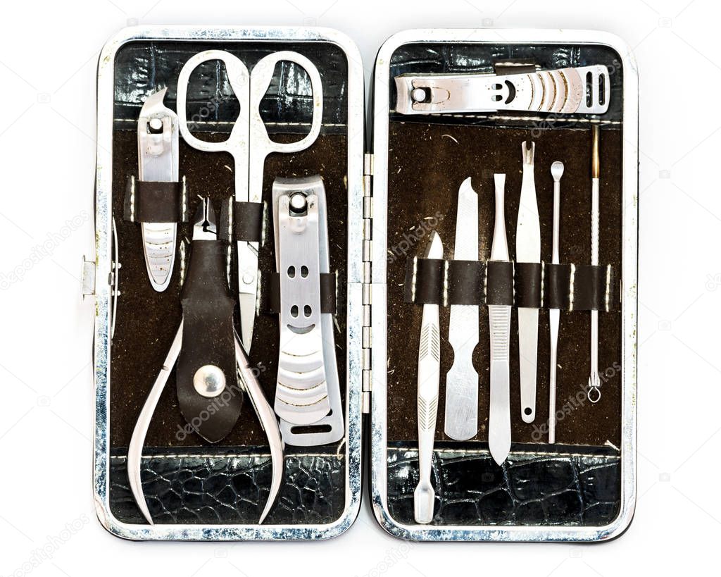 Top view close-up pedicure kit, nail clippers, professional grooming kit, nail tools with travel case isolated on white background.
