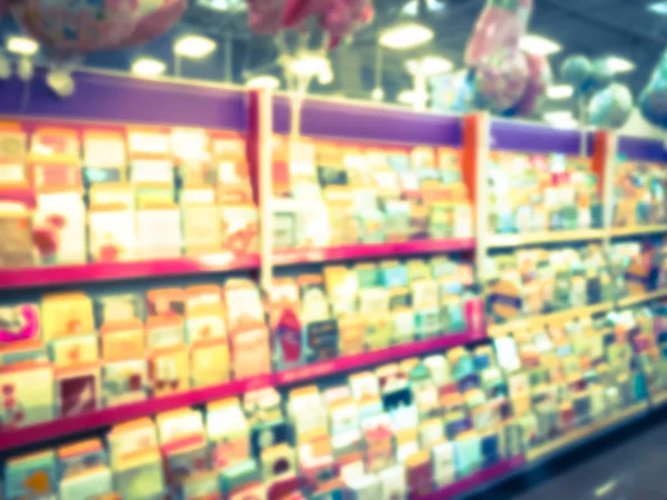 Filtered image blurry background wide selection of greeting cards display at a supermarket in USA