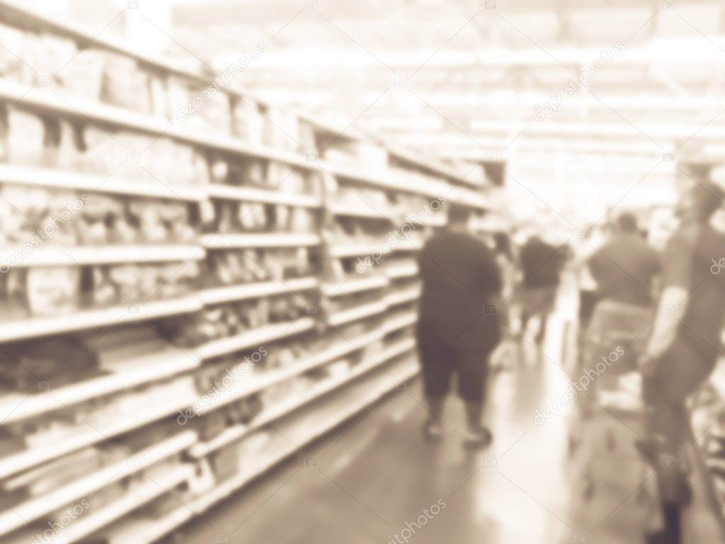 Blurry background customers with shopping cart stock up candy at grocery stores in America