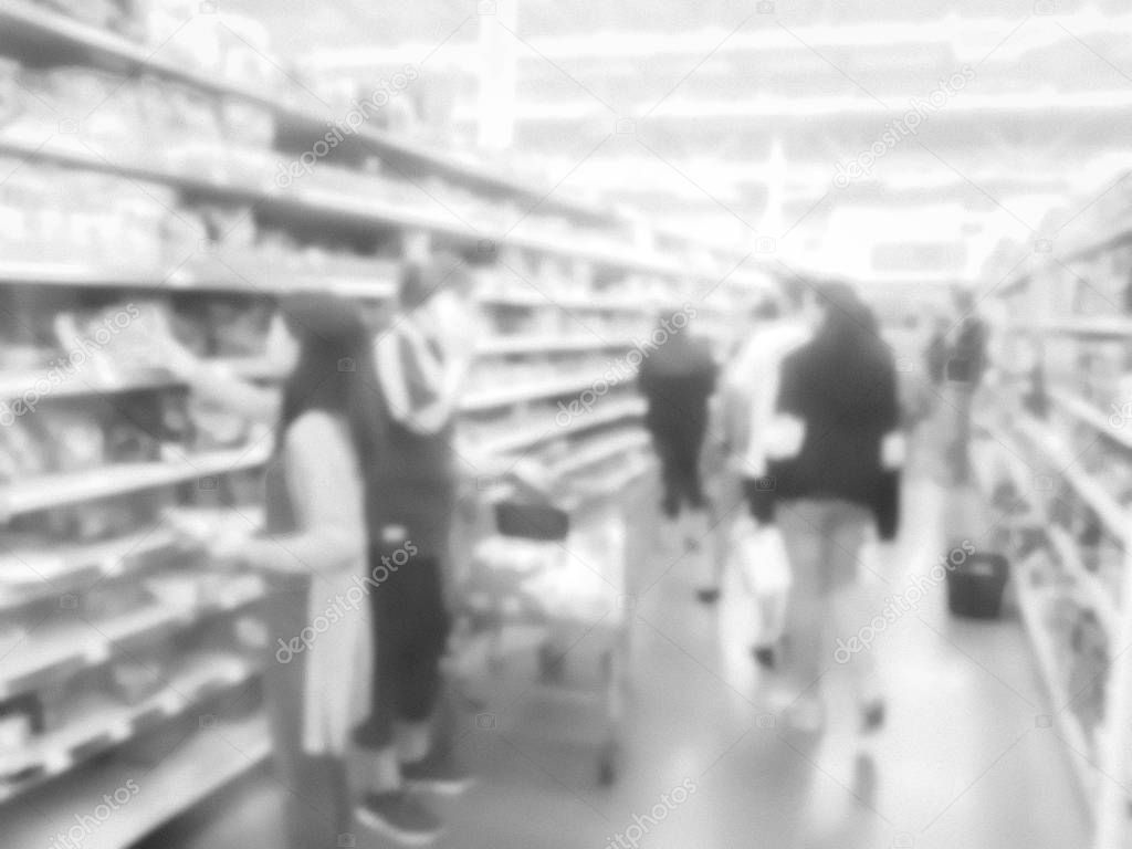 Filtered image blurry background diverse customers stock up candy at grocery stores in USA