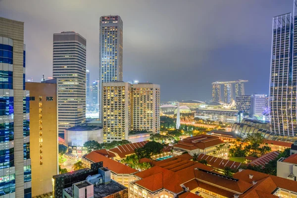 Singapore HDB building complex and downtown skylines illuminated in blue hour