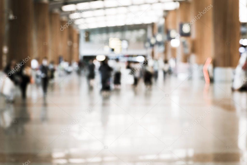 Filtered image blurry background passengers walking along corridor at Changi airport in Singapore