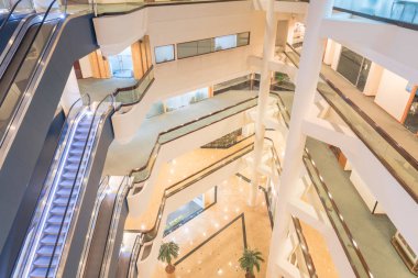 Aerial view interior of modern building with stack of escalator in Singapore