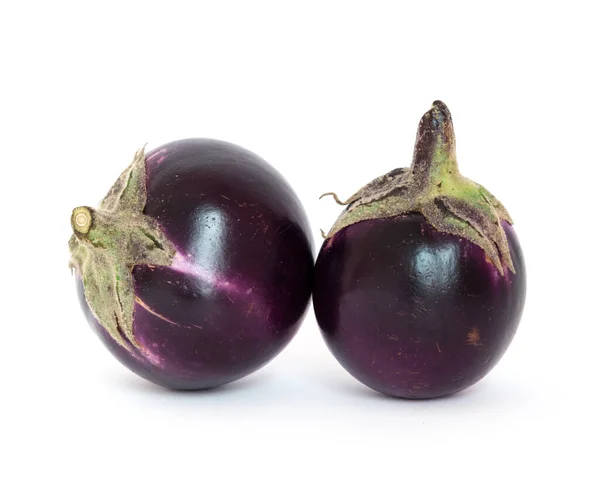 Studio shot of two organic violet round Thai eggplant isolated on white — Stok fotoğraf